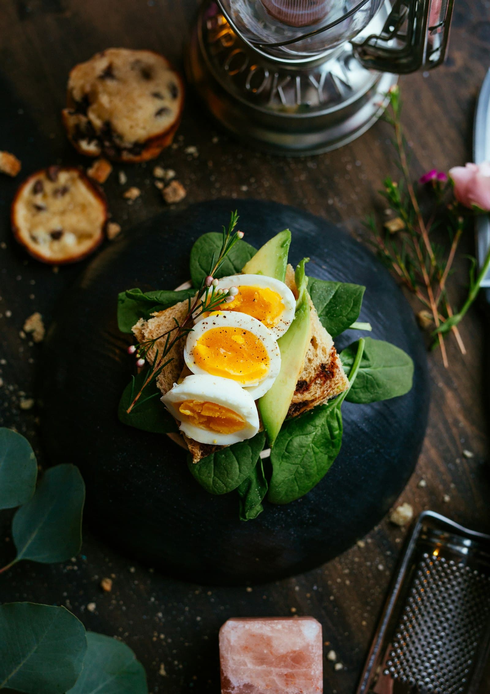 Avocado toast with soft-boiled eggs on a dark plate