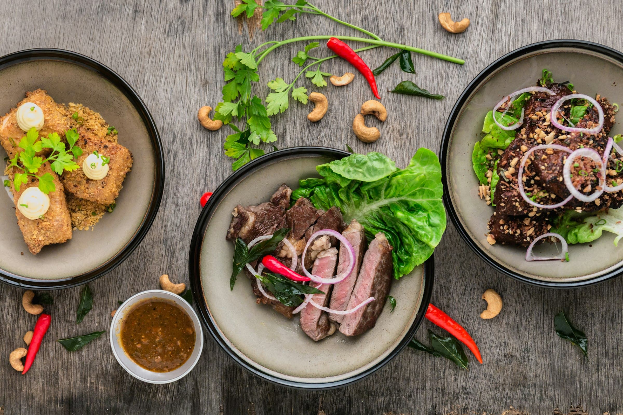Fresh vegetables, herbs and healthy ingredients arranged on a dark surface